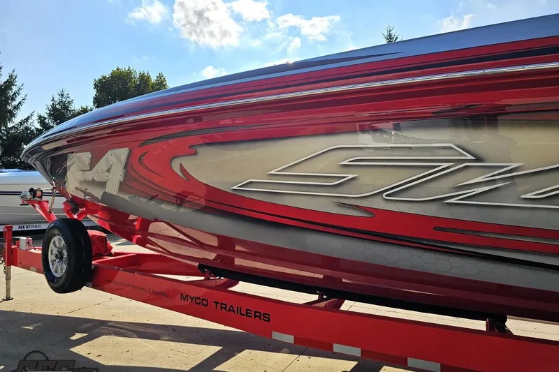 Slide: The Image of 2011 Sunsation F-4 speedboat on a red Myco trailer, showcasing sleek design and vibrant colors. - 23