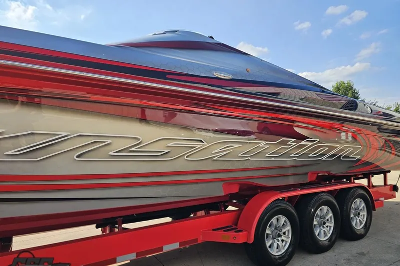 Slide: The Image of 2011 Sunsation F-4 powerboat with sleek red and silver design on a trailer. - 24