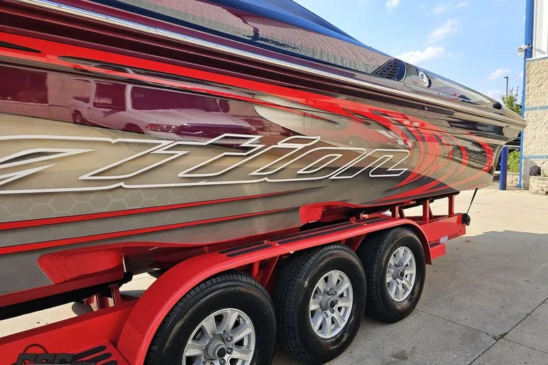 Slide: The Image of 2011 Sunsation F-4 boat on red trailer, featuring sleek design and vibrant graphics. - 25