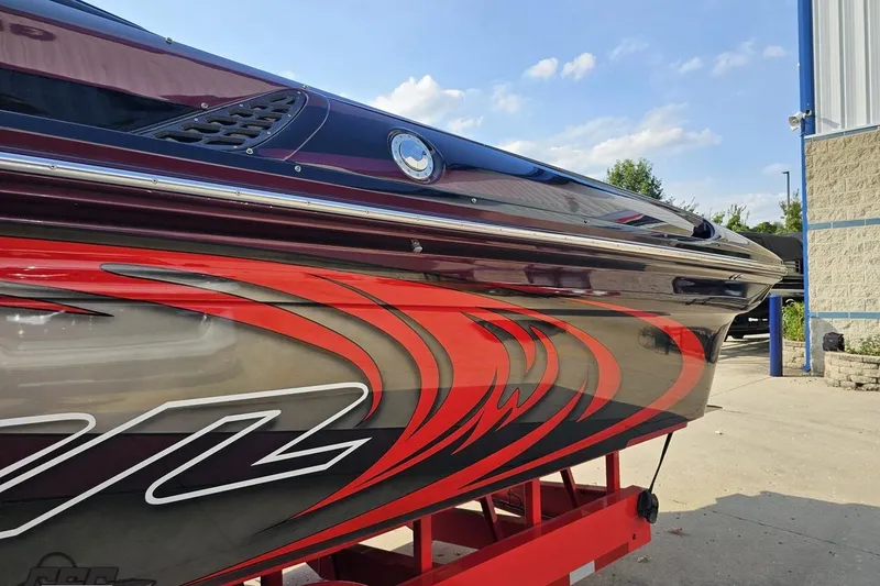 Slide: The Image of 2011 Sunsation F-4 boat with vibrant red and black graphics on the side. - 26