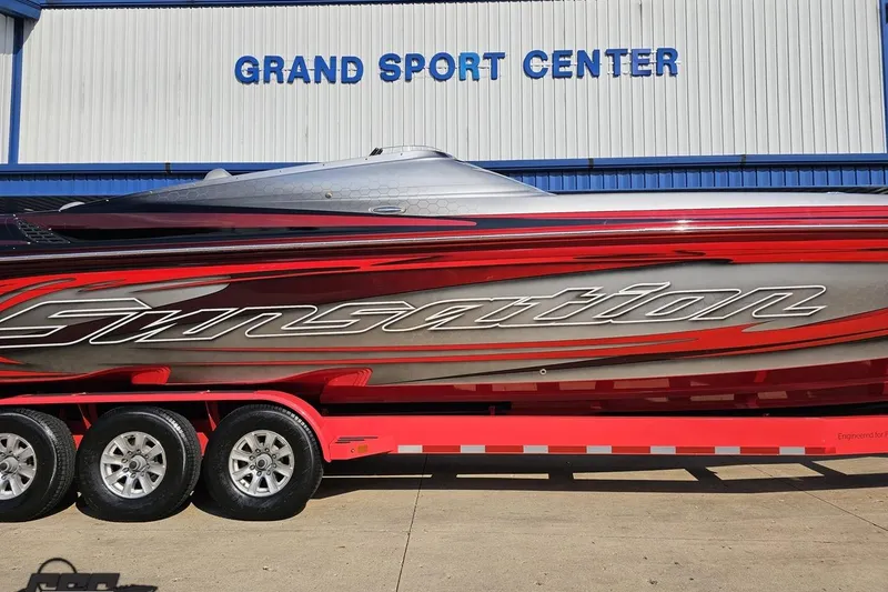 Slide: The Image of 2011 Sunsation F-4 boat at Grand Sport Center, featuring sleek red and silver design. - 3