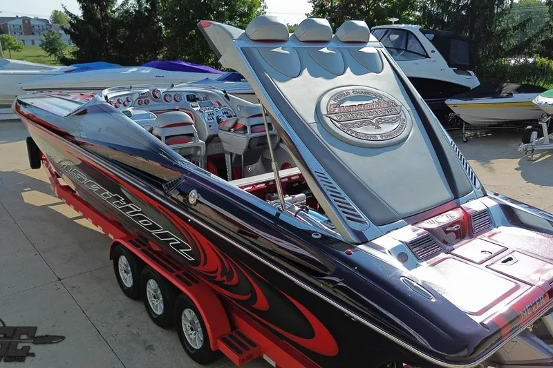 Slide: The Image of 2011 Sunsation F-4 powerboat with sleek design and vibrant colors on a trailer. - 32