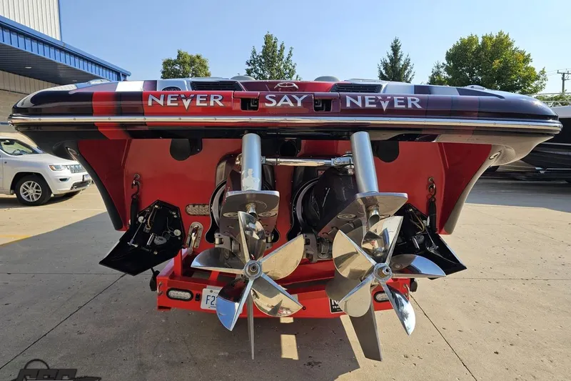 Slide: The Image of 2011 Sunsation F-4 boat with dual propellers, featuring "Never Say Never" text. - 35