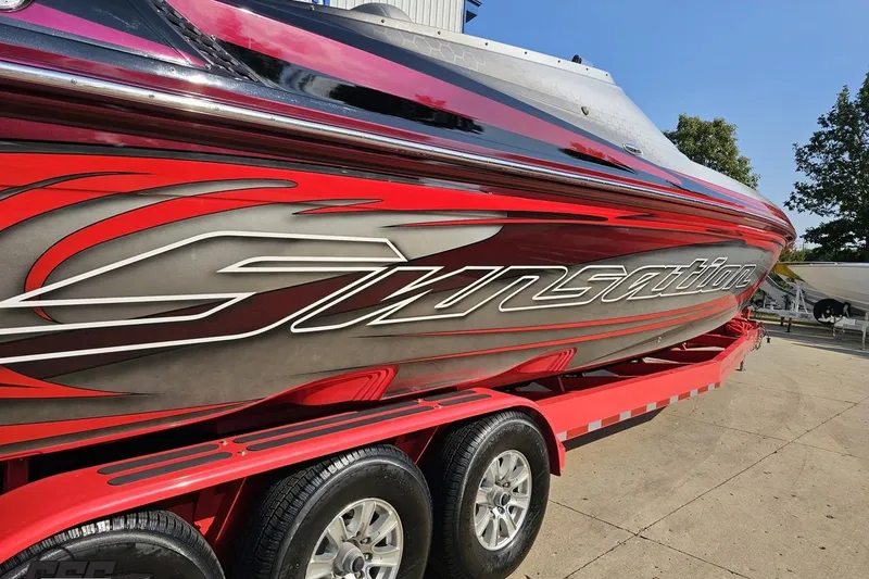 Slide: The Image of 2011 Sunsation F-4 speedboat with red and silver design on a trailer. - 39