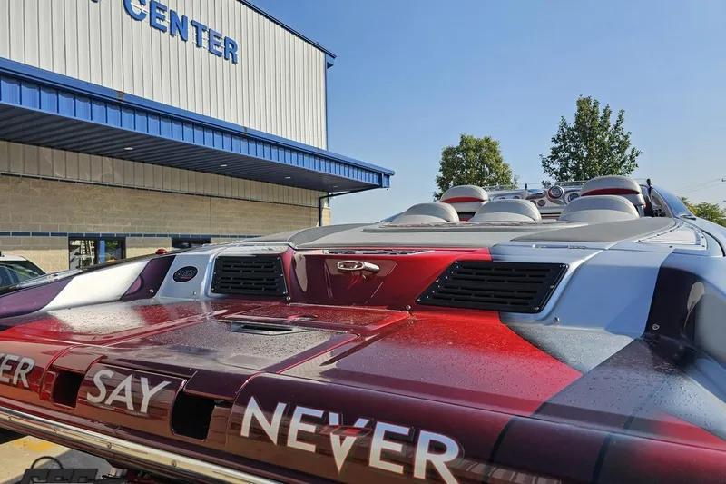 Slide: The Image of 2011 Sunsation F-4 speedboat with sleek design, parked near a service center. - 40