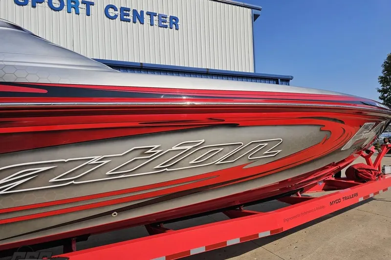 Slide: The Image of 2011 Sunsation F-4 boat with red and silver detailing on a trailer. - 5