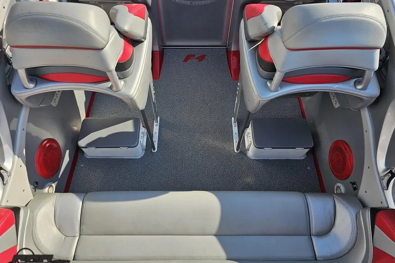 Slide: The Image of Interior of a 2011 Sunsation F-4 boat with gray and red seating. - 50