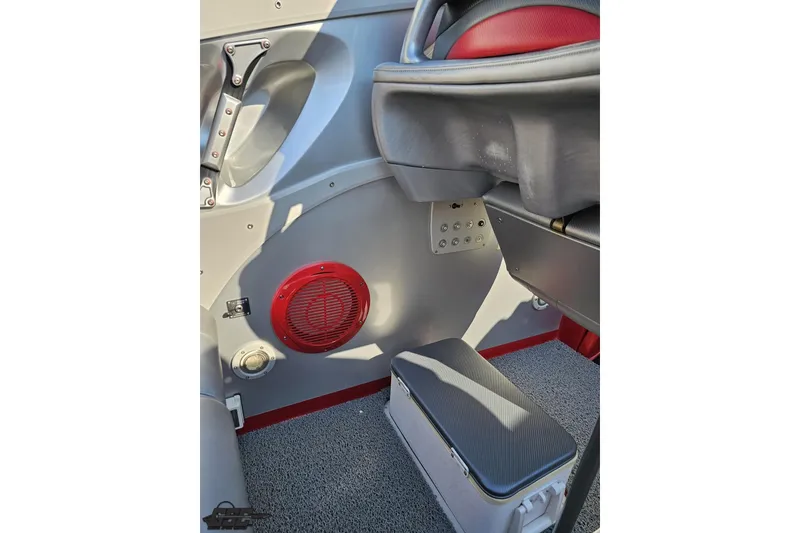 Slide: The Image of Interior of 2011 Sunsation F-4 boat with red speaker and gray seating. - 54