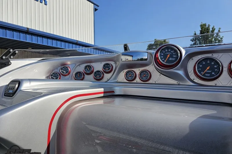 Slide: The Image of Dashboard of a 2011 Sunsation F-4 boat with multiple gauges and sleek design. - 58