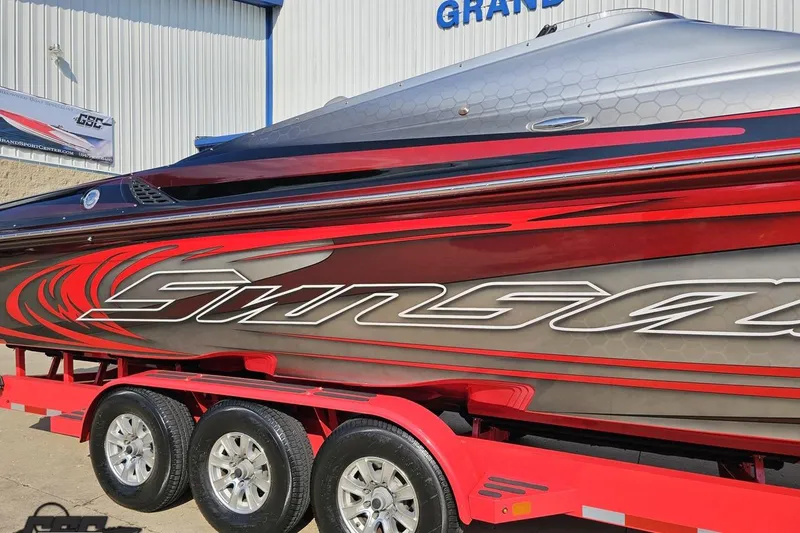 Slide: The Image of 2011 Sunsation F-4 powerboat with vibrant red and gray design on a trailer. - 6