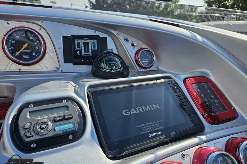 Slide: The Image of Dashboard of a 2011 Sunsation F-4 boat featuring Garmin and Kenwood devices. - 65