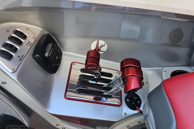 Slide: The Image of 2011 Sunsation F-4 boat controls with red throttle levers and digital display. - 66