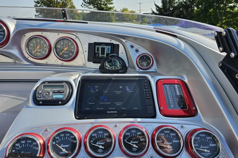 Slide: The Image of Dashboard of a 2011 Sunsation F-4 boat with gauges and Garmin navigation system. - 67