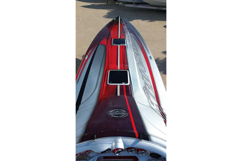 Slide: The Image of 2011 Sunsation F-4 boat with sleek red and silver design on deck. - 69