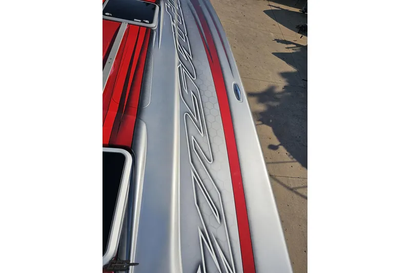 Slide: The Image of 2011 Sunsation F-4 boat with sleek red and silver design on deck. - 70