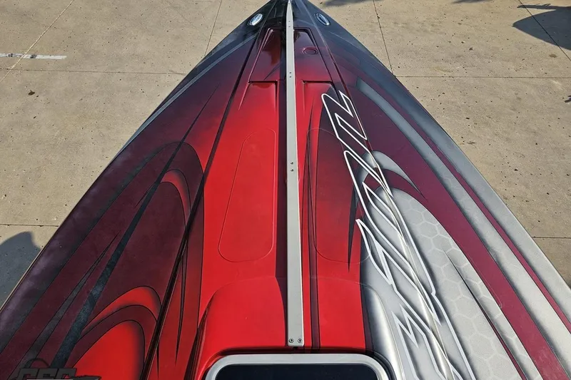 Slide: The Image of 2011 Sunsation F-4 boat with sleek red and gray design on deck. - 72