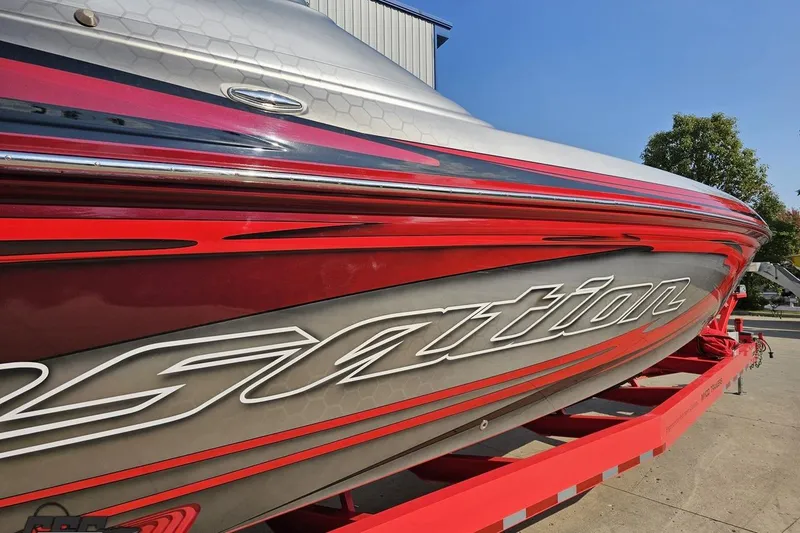 Slide: The Image of 2011 Sunsation F-4 boat with sleek red and silver design on a trailer. - 8