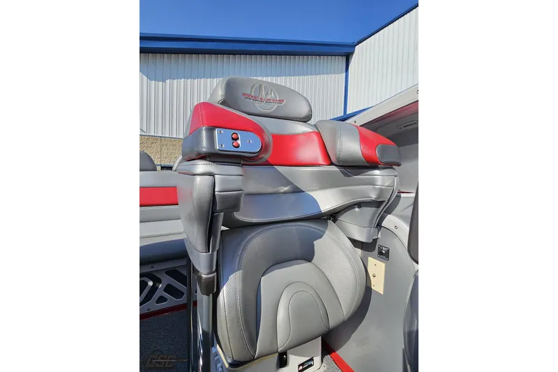 Slide: The Image of 2011 Sunsation F-4 boat seat with red and gray upholstery, featuring control buttons. - 88