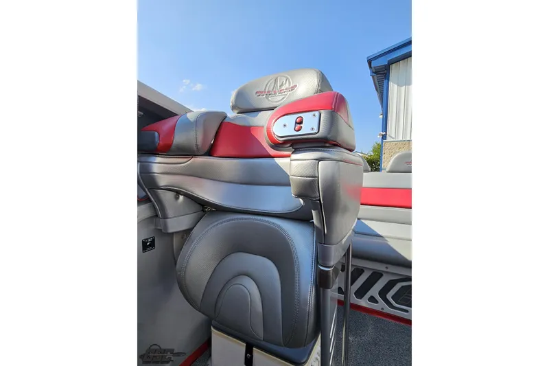 Slide: The Image of 2011 Sunsation F-4 boat seat with red and gray leather upholstery, outdoor setting. - 90
