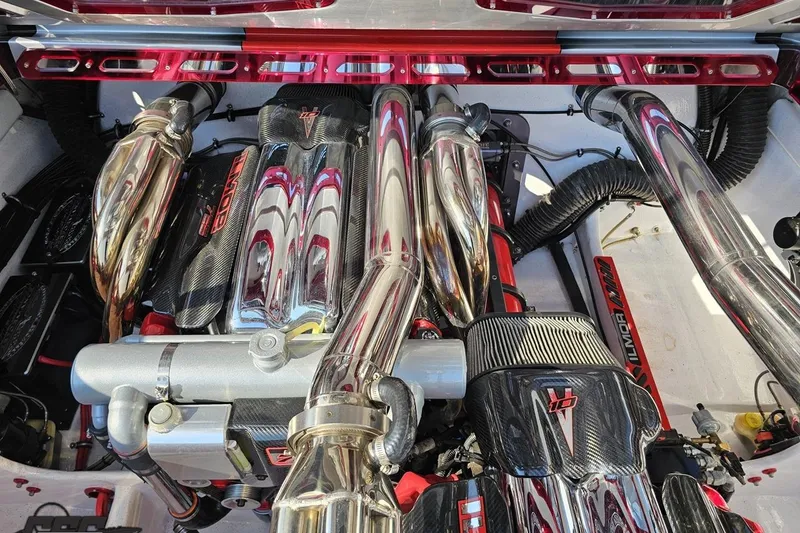 Slide: The Image of High-performance engine of a 2011 Sunsation F-4 boat, featuring polished chrome components. - 99