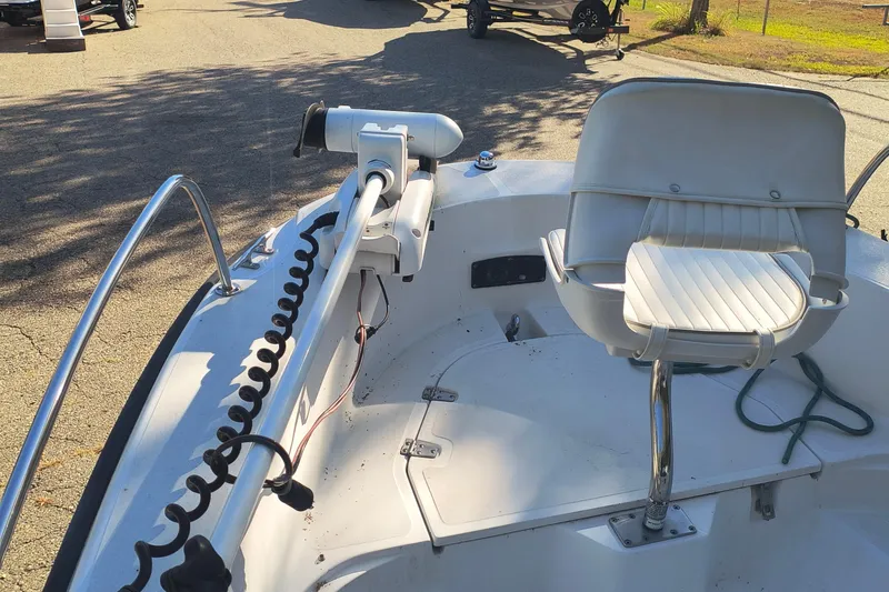 Slide: The Image of 2002 Boston Whaler 180 Dauntless boat interior with seating and mounted equipment. - 13