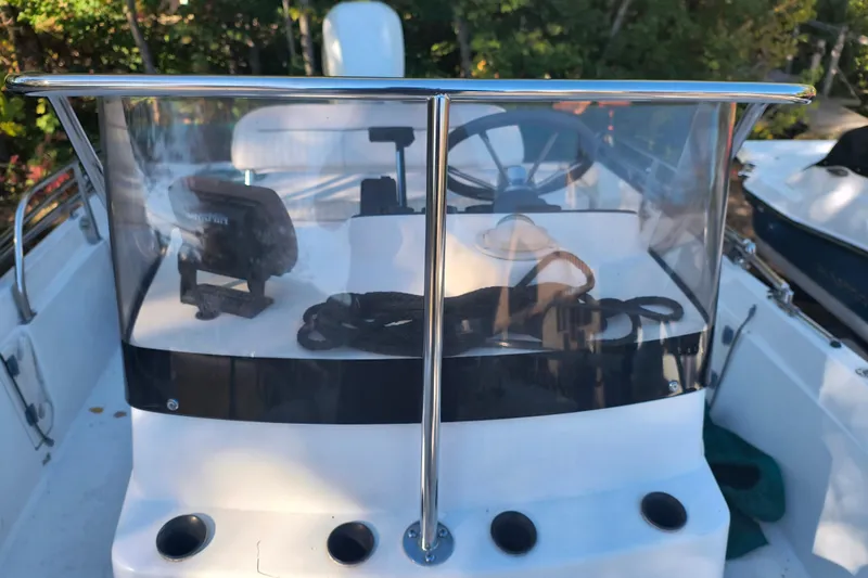 Slide: The Image of 2002 Boston Whaler 180 Dauntless boat console with steering wheel and navigation equipment. - 20