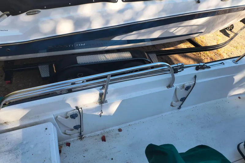 Slide: The Image of 2002 Boston Whaler 180 Dauntless boat interior with railing and storage area. - 22