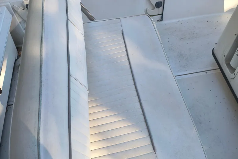 Slide: The Image of 2002 Boston Whaler 180 Dauntless boat seat, white upholstery, slightly worn condition. - 7