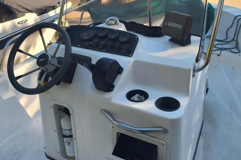 Slide: The Image of 2002 Boston Whaler 180 Dauntless boat console with steering wheel and Garmin device. - 8