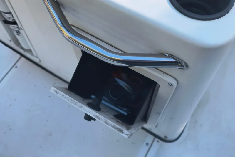 Slide: The Image of 2002 Boston Whaler 180 Dauntless boat compartment with chrome handle and open storage. - 9