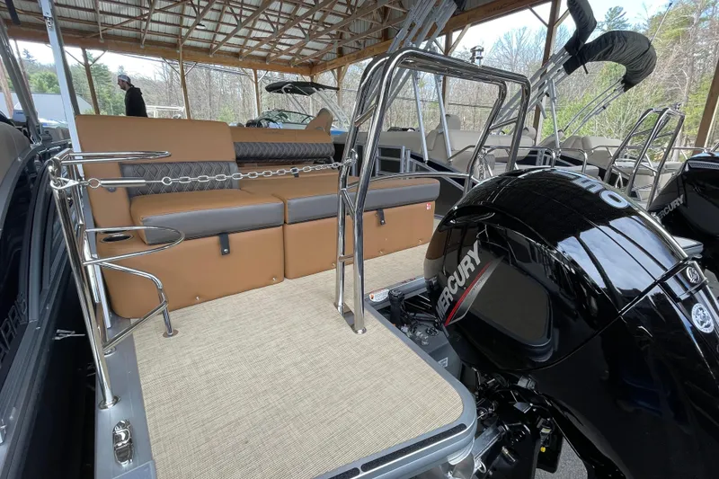 Slide: The Image of 2026 Harris Cruiser 210 pontoon boat with Mercury engine, featuring tan seating and stainless steel railings. - 16