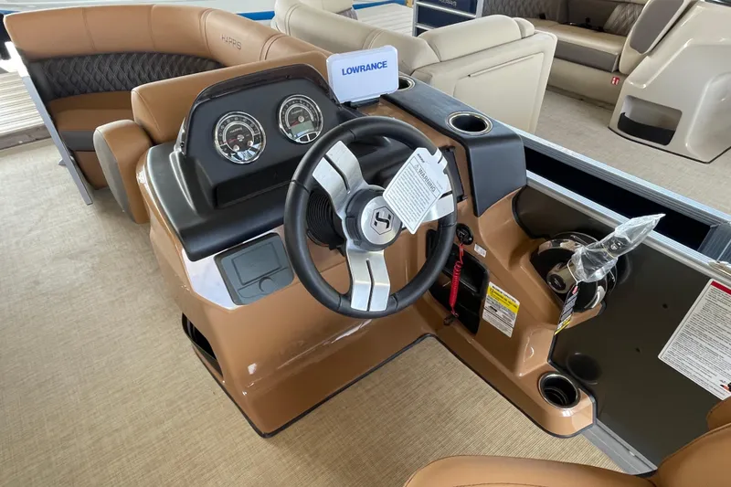 Slide: The Image of 2026 Harris Cruiser 210 boat dashboard with steering wheel and control panel. - 3