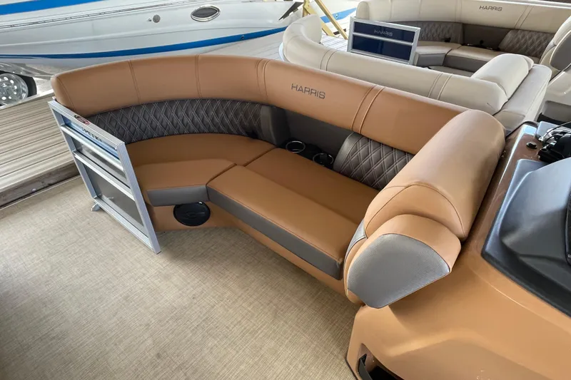 Slide: The Image of 2026 Harris Cruiser 210 boat interior with tan and gray seating. - 5