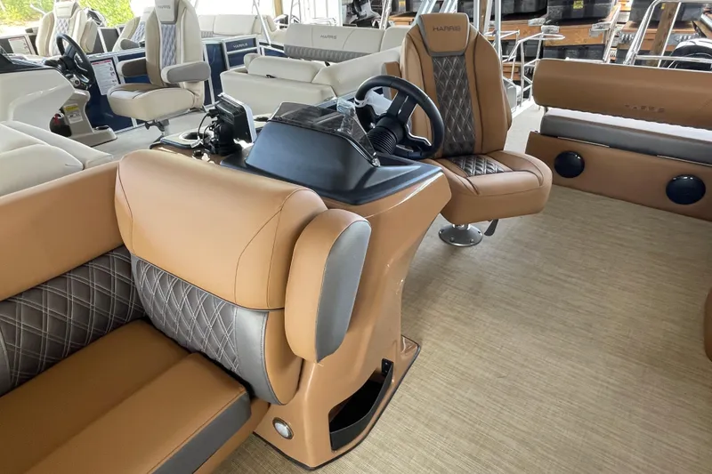 Slide: The Image of 2026 Harris Cruiser 210 interior with luxurious tan and gray seating. - 6