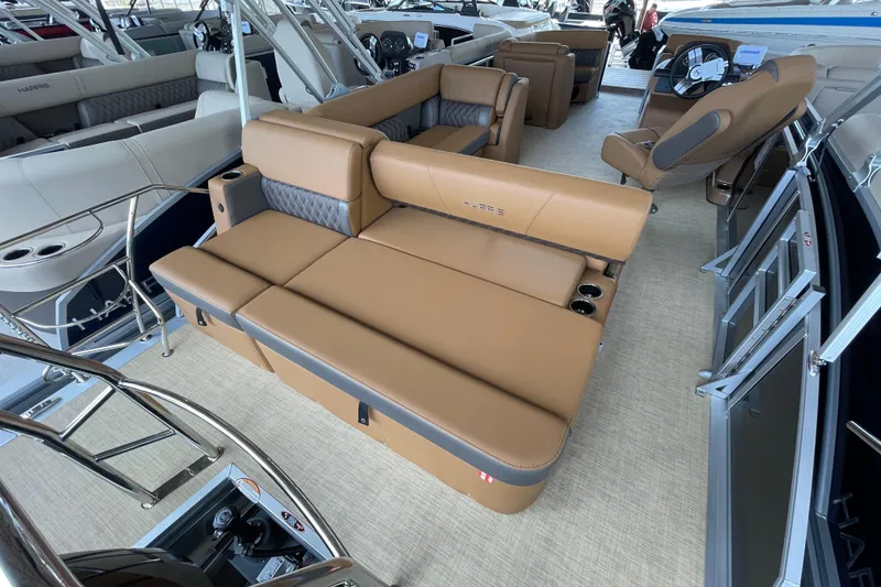 Slide: The Image of 2026 Harris Cruiser 210 boat interior with luxurious tan seating and modern design. - 9
