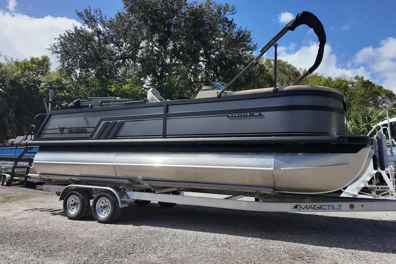 The Image of 2026 Viaggio Diamante D22S pontoon boat on trailer, parked outdoors. - 0