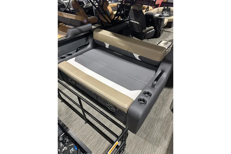 Slide: The Image of 2026 Viaggio Diamante D22S boat interior with beige and gray seating, cup holders, and modern design. - 17