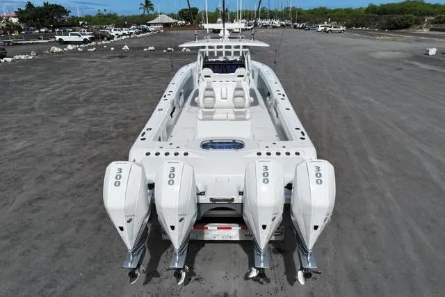 Slide: The Image of 2022 Freeman 37 VH boat with four 300 horsepower engines, parked on a concrete surface. - 17