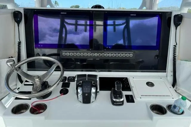 Slide: The Image of 2022 Freeman 37 VH boat dashboard with dual screens, steering wheel, and controls. - 19