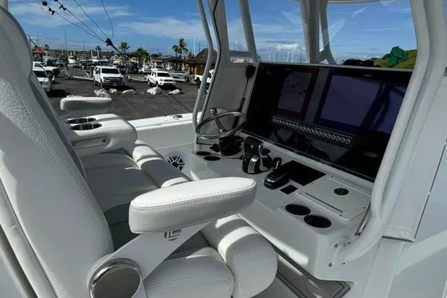 Slide: The Image of 2022 Freeman 37 VH boat cockpit with modern controls and white seating. - 24