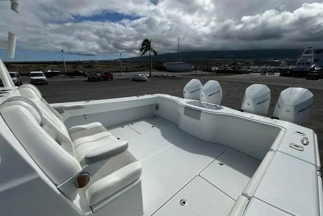 Slide: The Image of Freeman 37 VH 2022 boat with spacious deck and multiple engines, parked at marina. - 25