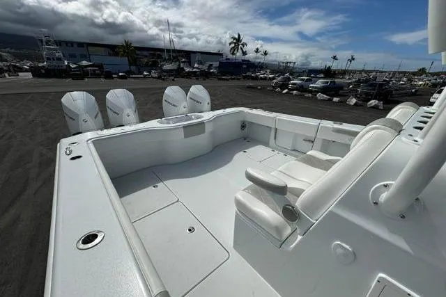Slide: The Image of 2022 Freeman 37 VH boat with spacious deck and multiple outboard engines, docked under cloudy skies. - 26