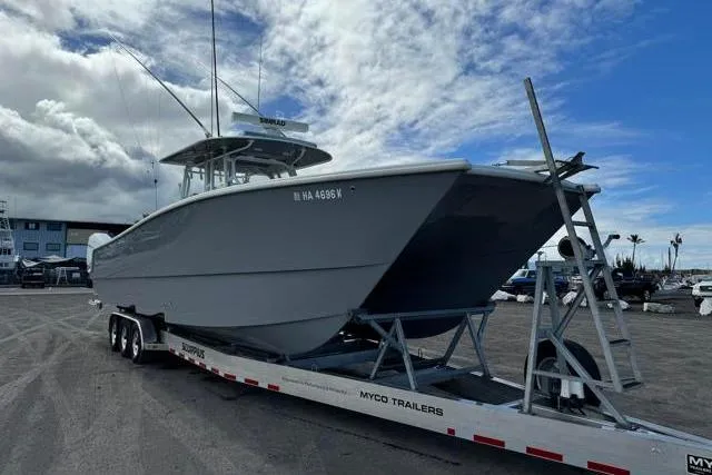 Slide: The Image of 2022 Freeman 37 VH boat on Myco trailer under cloudy sky. - 28