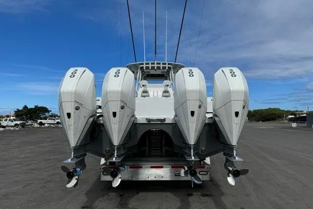 Slide: The Image of 2022 Freeman 37 VH boat with four powerful outboard engines, parked on a trailer. - 31