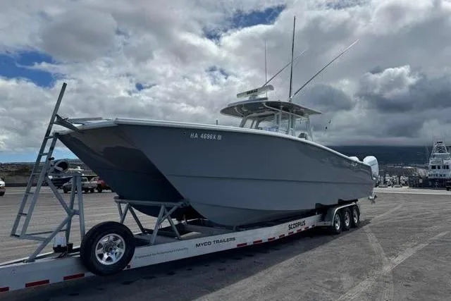 Slide: The Image of 2022 Freeman 37 VH boat on trailer under cloudy sky. - 34