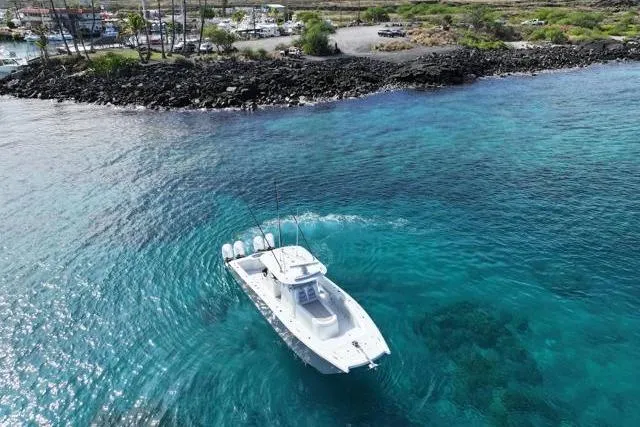 Slide: The Image of Aerial view of 2022 Freeman 37 VH boat on clear turquoise water near rocky shoreline. - 7
