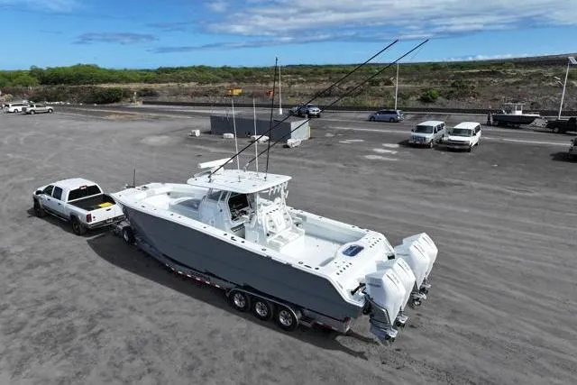 Slide: The Image of 2022 Freeman 37 VH boat on trailer, towed by a truck in a parking lot. - 9