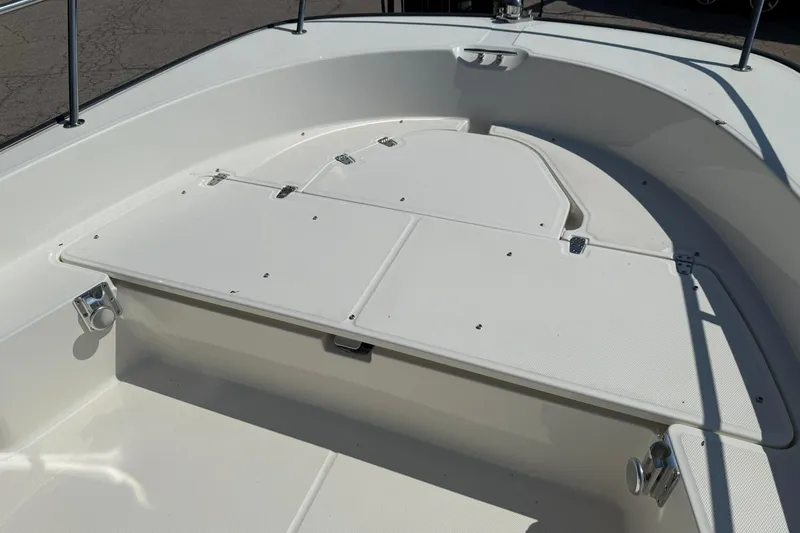 Slide: The Image of 2014 Boston Whaler 210 Montauk boat deck, featuring spacious storage compartments. - 14