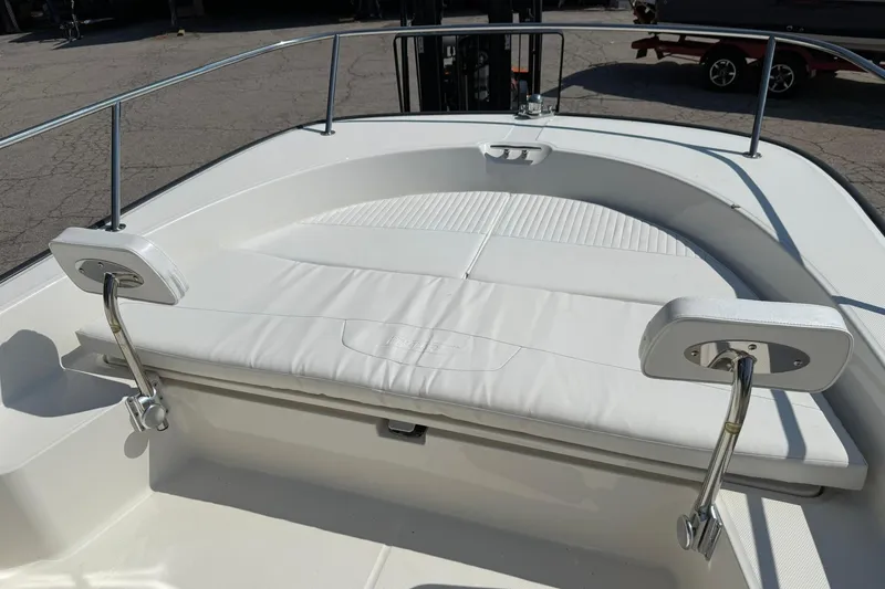 Slide: The Image of 2014 Boston Whaler 210 Montauk boat interior with white cushioned seating. - 15