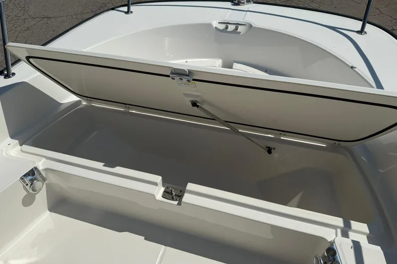 Slide: The Image of Open storage compartment on a 2014 Boston Whaler 210 Montauk boat. - 16